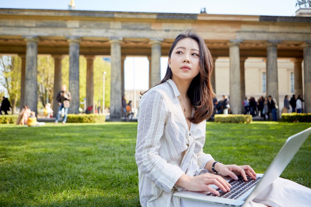 日本人が海外でパソコン作業をしているイメージの画像